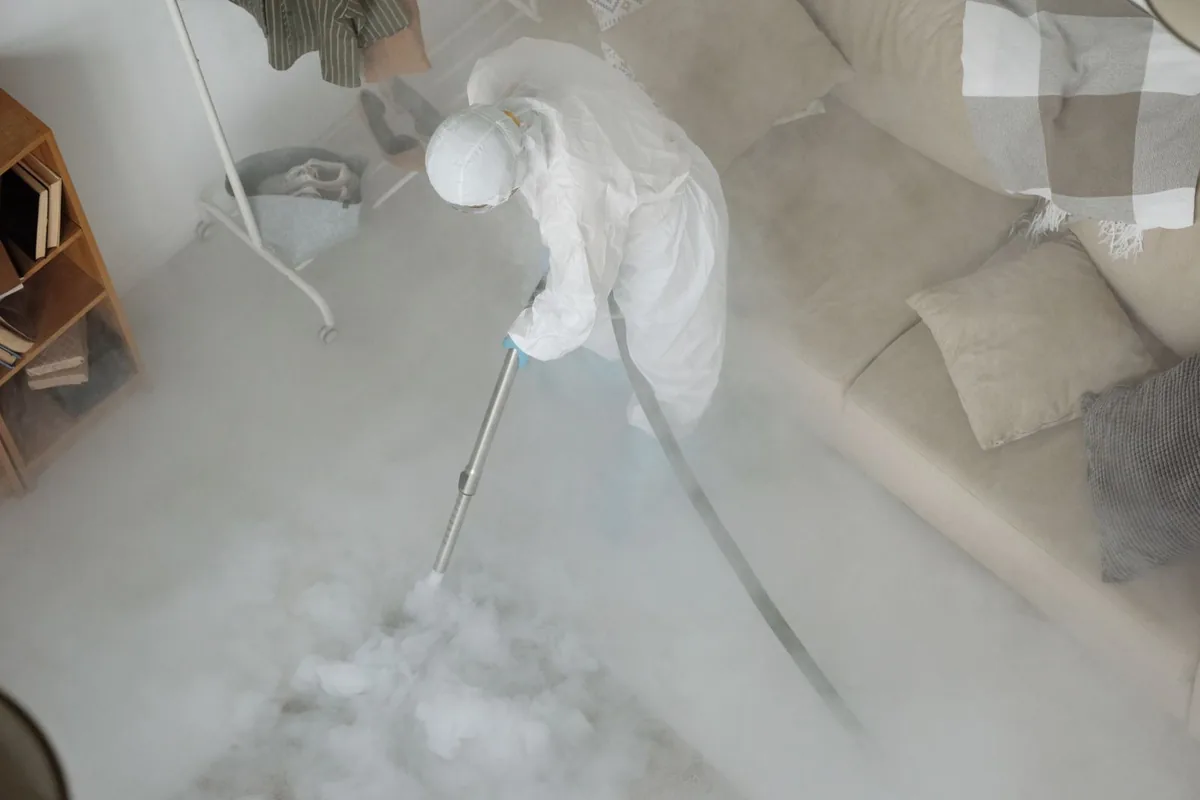 Biohazard cleanup technician in protective equipment, Wellsville, KS